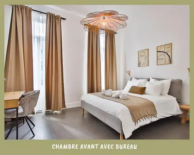 a bedroom with a large bed and a chandelier at La bulle bohème - Entièrement neuf, près de Spa in Verviers