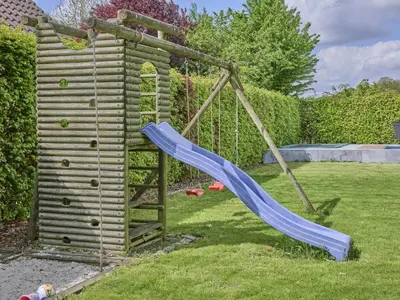 a playground with a slide in a yard at Bigaro 1 in Heers
