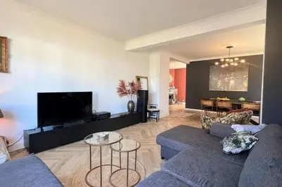 a living room with two couches and a tv at Vakantiewoning De Merode in Lanaken