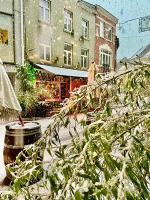 a snow covered street with a building in the background at The House Of Jack's in Hasselt