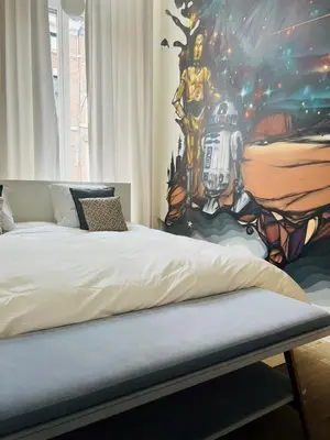 a bedroom with a football painting on the wall at Louvrex 78 in Liège