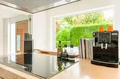 a kitchen with a glass counter top with a coffee maker at 8P 4B Lanaken Retreat: Swimming Pool Jacuzzi and Sauna in Lanaken