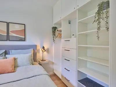a bedroom with a bed and a closet at De Eekhoorn in Zutendaal