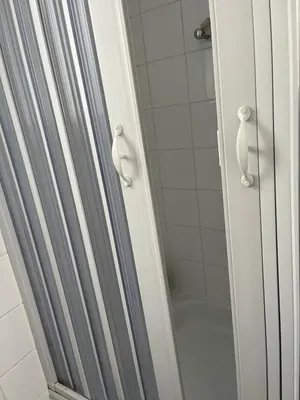 a shower with a glass door in a bathroom at Superbe studio calme et cosy in Saint-Léonard