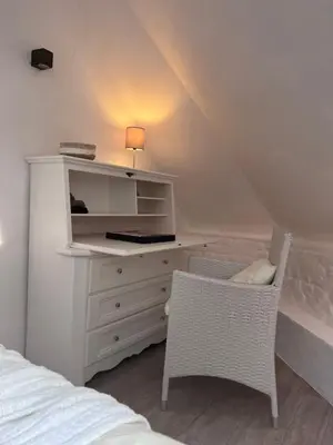 a bedroom with a desk and a bed and a chair at Petit Château in Eupen