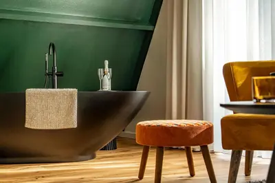 a bathroom with a bath tub and a sink at Boshuisje Rekem - Ignis in Lanaken