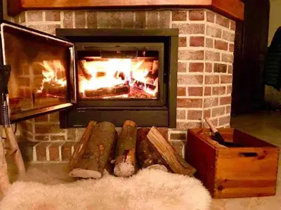 a brick fireplace with a fire in it at Happiness at Vero in Verviers