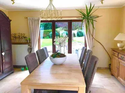 a dining room with a wooden table and chairs at Happiness at Vero in Verviers