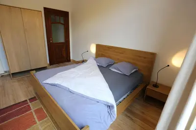 a bedroom with a bed with blue sheets and pillows at Bed and breakfast Le fourchu fossé in Liège