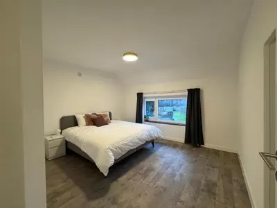 a bedroom with a bed and a window at Vakantiewoning Gruitrode in Oudsbergen