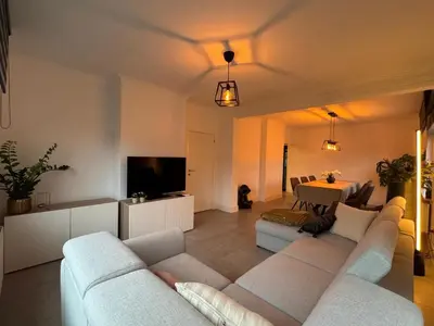 a living room with a couch and a table at Vakantiewoning Gruitrode in Oudsbergen