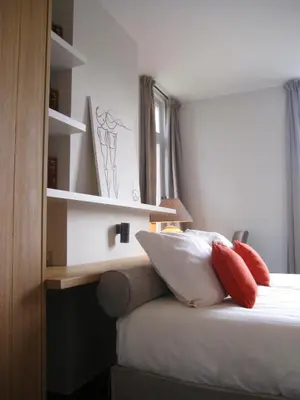 a bedroom with a bed with red pillows and shelves at O-Lit in Paal