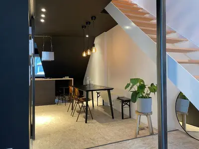 a dining room and kitchen with a table and chairs at Duplex in the historic heart of Liège - 3rd floor in Liège
