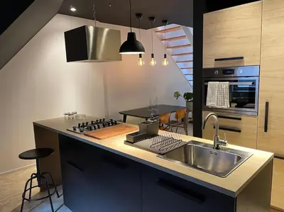 a kitchen with a sink and a stove at Duplex in the historic heart of Liège - 3rd floor in Liège