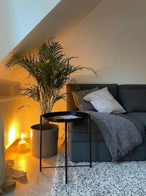 a living room with a blue couch and a table at Duplex in the historic heart of Liège - 3rd floor in Liège