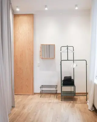 a room with a door and a bench next to a wall at 1 bedroom apartment in Liège center - 1st floor in Liège