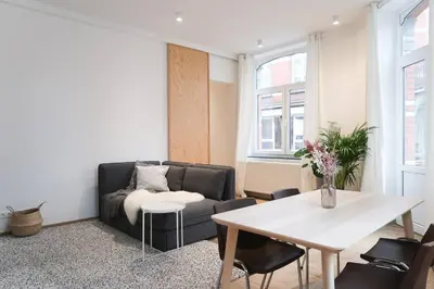 a living room with a couch and a table at 1 bedroom apartment in Liège center - 1st floor in Liège