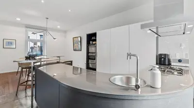 a kitchen with a sink and a counter top at Maison Quatre-Vingt-Deux in Maasmechelen