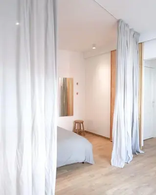 a bedroom with white curtains and a bed at 1 bedroom apartment in Liège center - 3rd floor in Liège