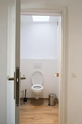 a bathroom with a white toilet in a room at 1 bedroom apartment in Liège center - 3rd floor in Liège