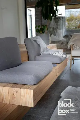 two couches on a wooden platform in a living room at Black Box by De Schrijfbar - vakantiewoning Haspengouw in Wellen