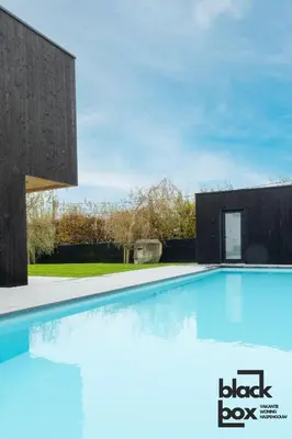 a swimming pool in the backyard of a house at Black Box by De Schrijfbar - vakantiewoning Haspengouw in Wellen