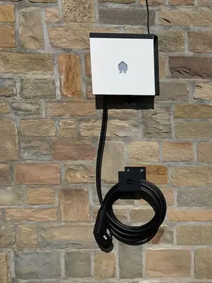 an apple laptop is plugged into a brick wall at Eaglenest in Baelen