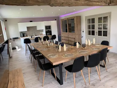 a dining room with a large wooden table and chairs at Eaglenest in Baelen