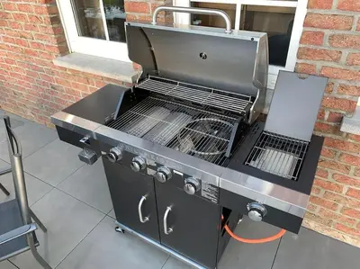 a grill sitting on a patio next to a brick building at Eaglenest in Baelen