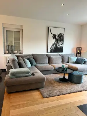 a living room with a couch and a table at De Boomgaard Voeren in Voeren