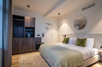 a bedroom with a large bed in a room at Boutique Hotel Annamaes, Maastricht-Hoge Kempen in Lanaken