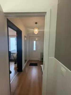 a hallway with a hallway leading to a living room at La Redoute in Tongeren