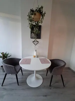 a white table and two chairs in a room at La Vie en Rose in Verviers