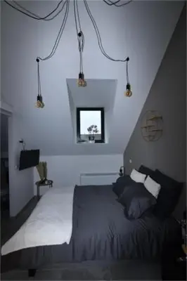 a bedroom with a bed and a window at B & B 't Pomphuys in Zoutleeuw