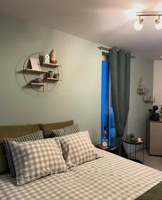 a bedroom with a bed and a shelf on the wall at B & B 't Pomphuys in Zoutleeuw