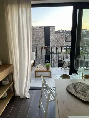 a living room with a view of a balcony at Casa Lariz in Hasselt