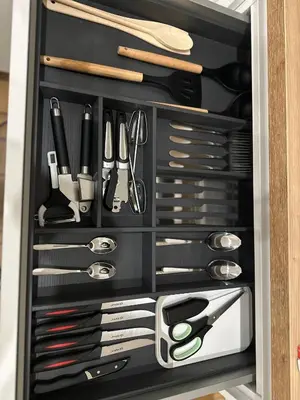 a drawer filled with lots of kitchen utensils at Appartement cosy à Liège in Liège