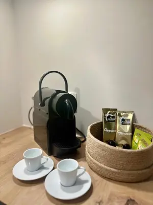 a table with two cups and a basket of coffee at Appartement cosy à Liège in Liège