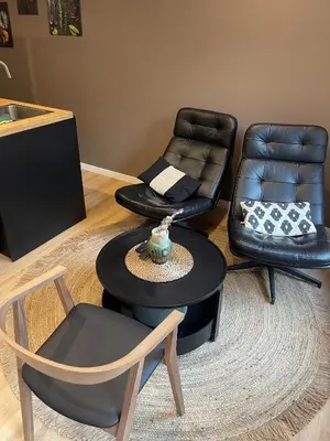 a living room with two chairs and a table and chairs at Magnifique appartement 1 chambre in Liège
