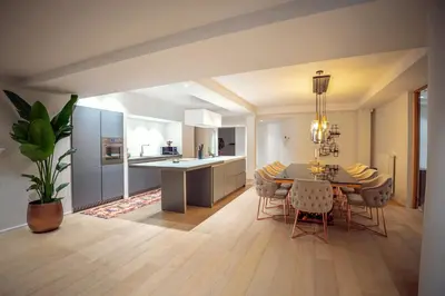 a kitchen and dining room with a table and chairs at Dream Saint Lambert in Liège