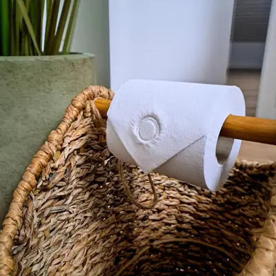 a roll of toilet paper in a basket at Chambre et salle de bain privative in Liège