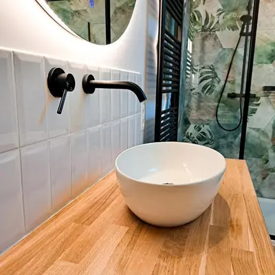 a white bowl on a wooden counter in a bathroom at Chambre et salle de bain privative in Liège