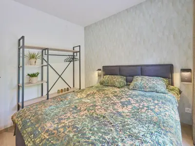 a bedroom with a large bed in a room at Zen en Zoet in Zutendaal