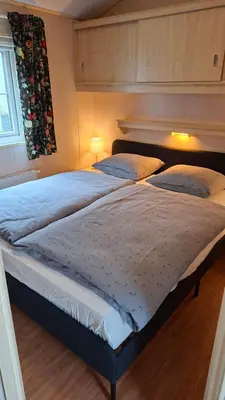 a bed in a bedroom with two pillows on it at Chalet nr 17 Park Bergzicht Teuven in Voeren