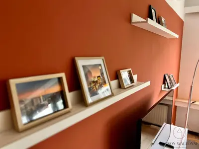 three framed photographs sitting on a shelf on a wall at L 'écrin sauvenière - Hypercentre avec Parking gratuit in Liège