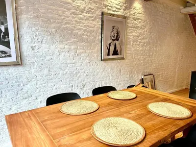 a wooden table with five straw hats on it at L'Atelier Triplex - Architect's apartment in Liège