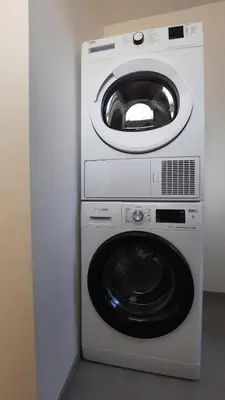a washing machine and a dryer in a room at Chambre d'hôte, la rouge in Liège