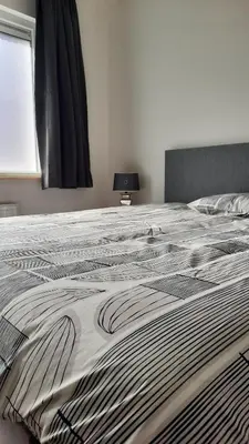 a large bed with a blanket on top of it at Chambres d'hôte, la grise in Liège