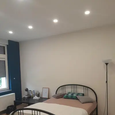 a bedroom with a bed and a desk and a window at RELAX Room in Chaudfontaine