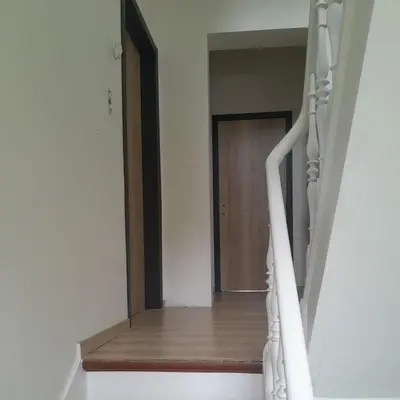 a white staircase with a wooden door in a room at RELAX Room in Chaudfontaine